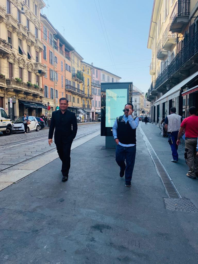Two men walking down a city.